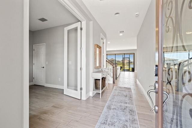 hallway with light hardwood / wood-style flooring