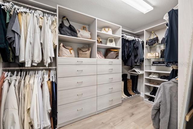 spacious closet featuring light wood-type flooring