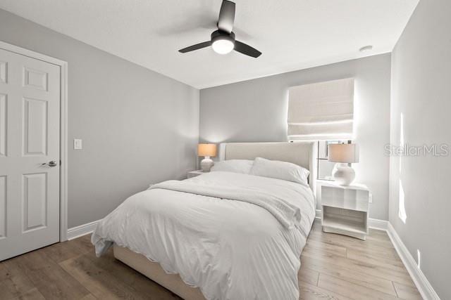 bedroom featuring ceiling fan and light hardwood / wood-style flooring