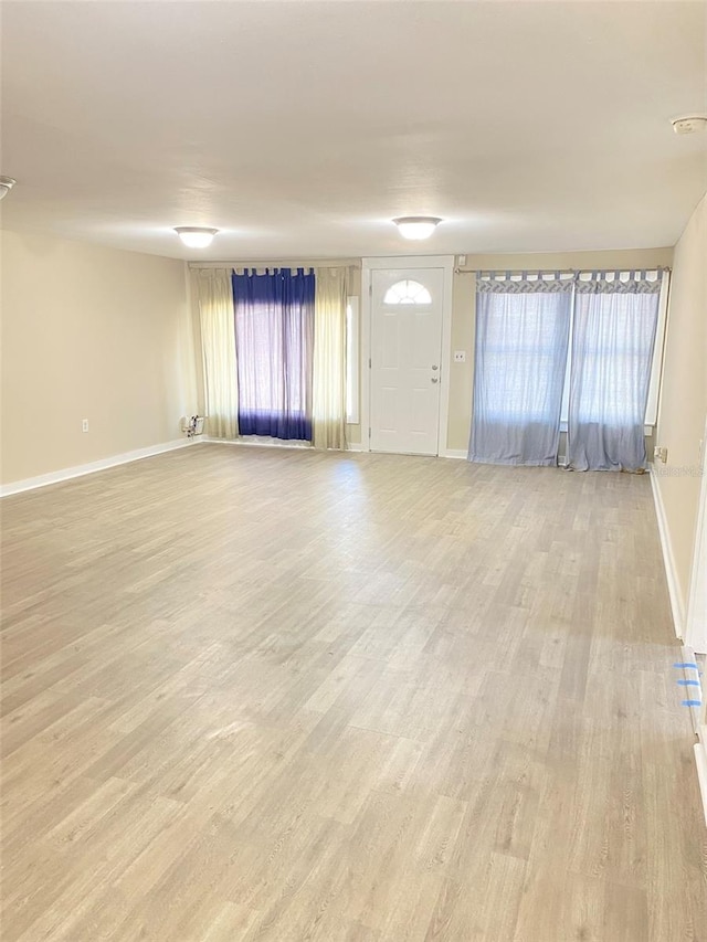 unfurnished living room with plenty of natural light and light wood-type flooring