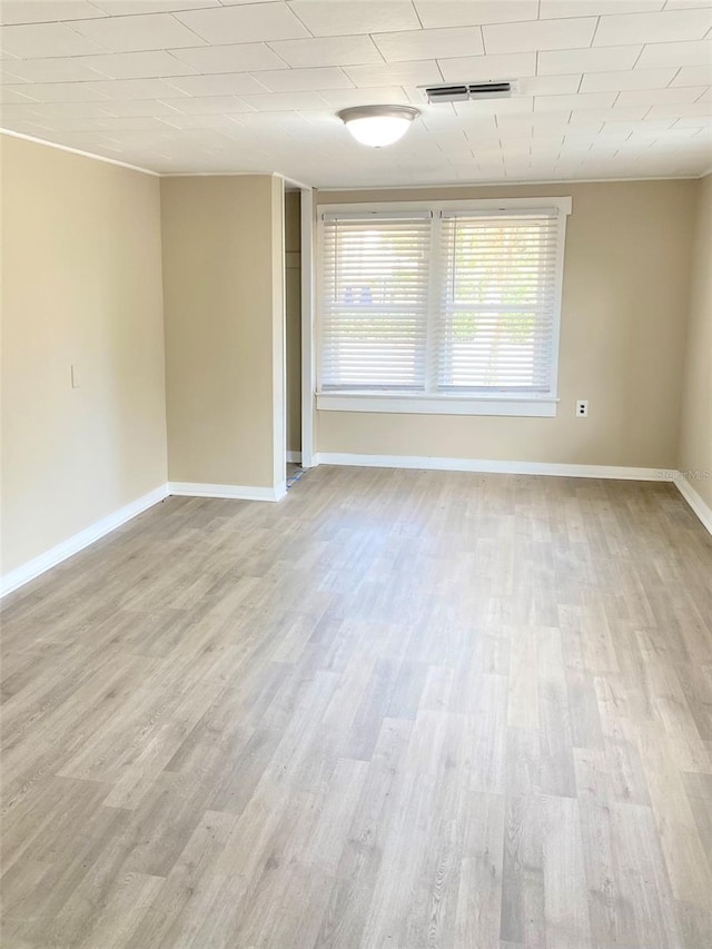 spare room featuring light hardwood / wood-style flooring