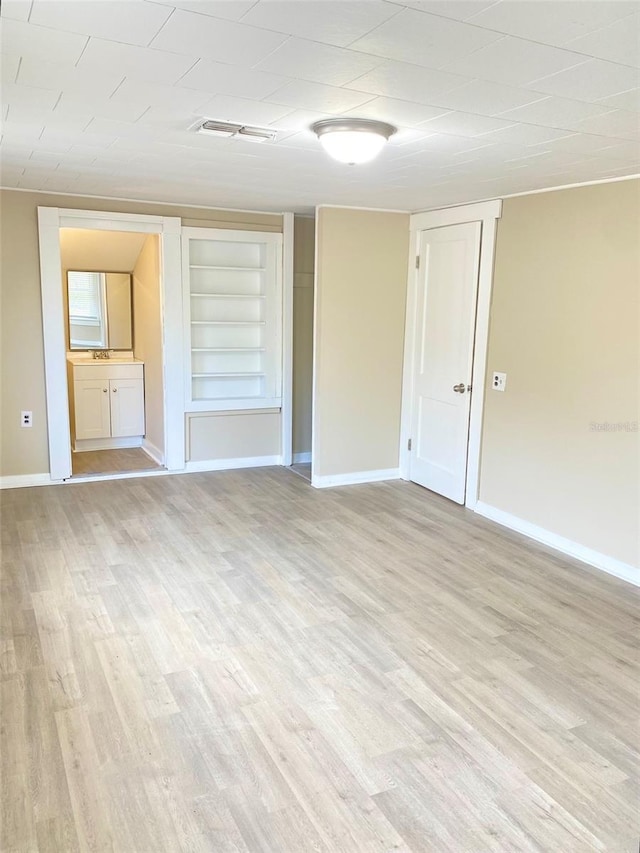 spare room with light wood-type flooring