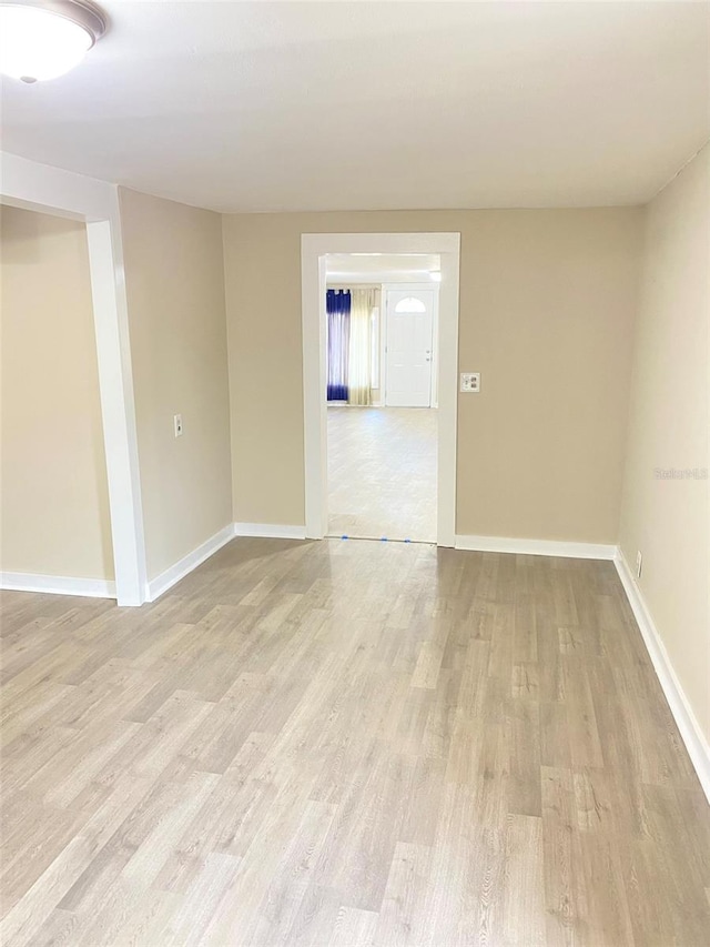 spare room featuring light wood-type flooring