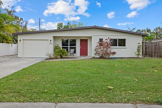 ranch-style house with a front lawn and a garage