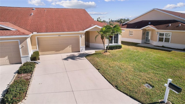 ranch-style house featuring a garage and a front yard