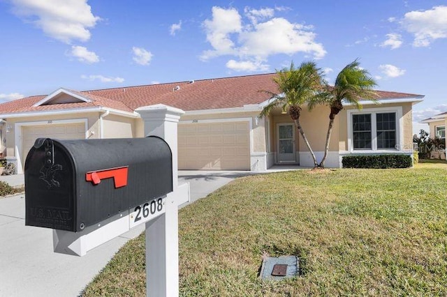 view of front of property featuring a garage and a front yard