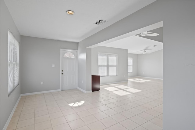 foyer featuring light tile patterned floors and ceiling fan