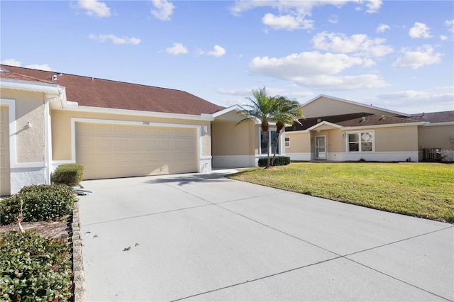 ranch-style house with cooling unit, a garage, and a front yard