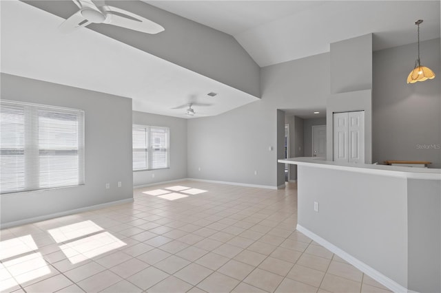 unfurnished living room with high vaulted ceiling, light tile patterned floors, and ceiling fan