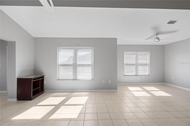 tiled empty room featuring ceiling fan and vaulted ceiling