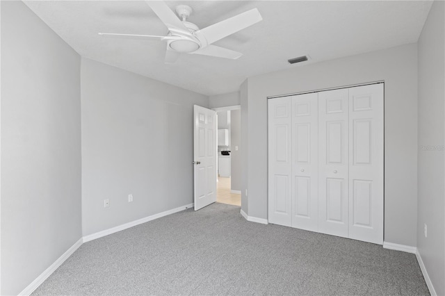 unfurnished bedroom featuring ceiling fan, carpet floors, and a closet