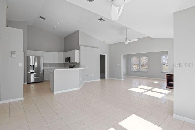 kitchen featuring light tile patterned flooring, white cabinetry, high vaulted ceiling, ceiling fan, and stainless steel appliances