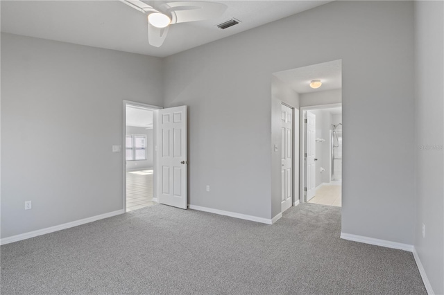 carpeted empty room featuring ceiling fan