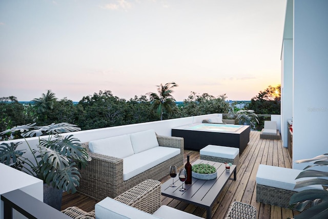 deck at dusk with outdoor lounge area and a hot tub