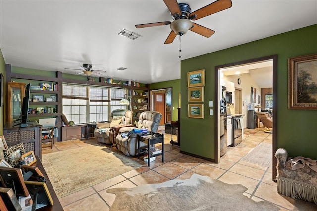 tiled living room with ceiling fan