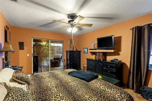 bedroom featuring tile patterned floors, a textured ceiling, access to exterior, and ceiling fan