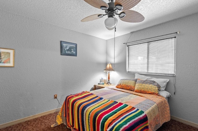 bedroom with a textured ceiling, dark carpet, and ceiling fan