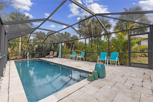 view of swimming pool featuring a lanai and a patio area