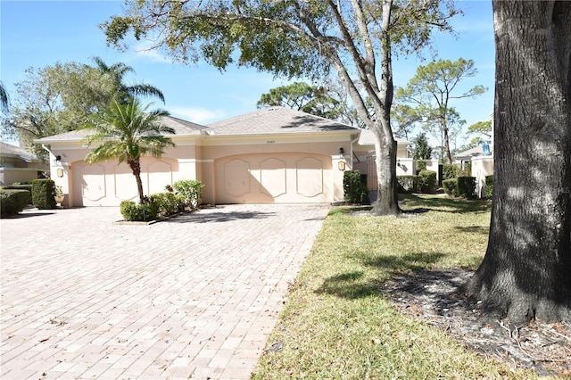 view of front of property featuring a garage and a front lawn