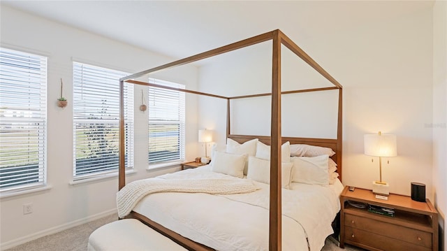 bedroom featuring carpet floors and baseboards