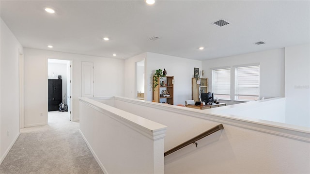 corridor with light colored carpet, visible vents, an upstairs landing, and recessed lighting