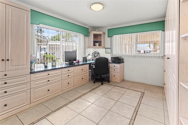 tiled office space featuring a textured ceiling