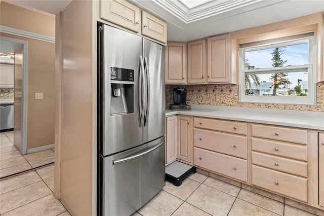 kitchen with crown molding, tasteful backsplash, light tile patterned floors, light brown cabinets, and appliances with stainless steel finishes