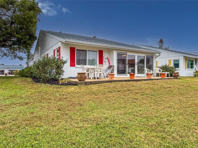 rear view of property featuring a yard