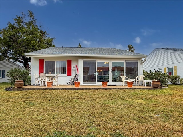 rear view of property with a patio and a yard