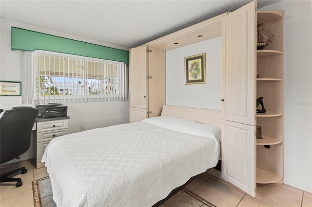 tiled bedroom featuring a textured ceiling