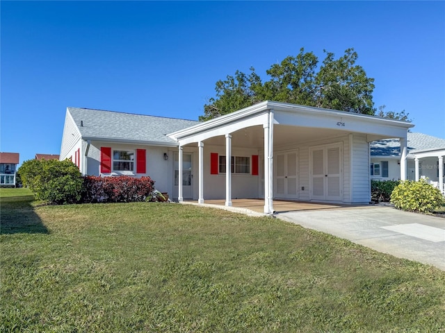 4714 Potomac Cir, Bradenton, FL 34210 - view of front of house featuring a carport, a front lawn, and concrete driveway