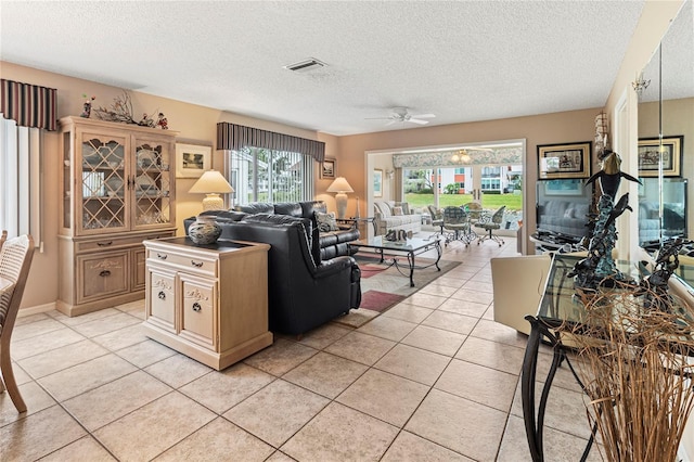 4714 Potomac Cir, Bradenton, FL 34210 - living room with light tile patterned floors, a textured ceiling, and a ceiling fan