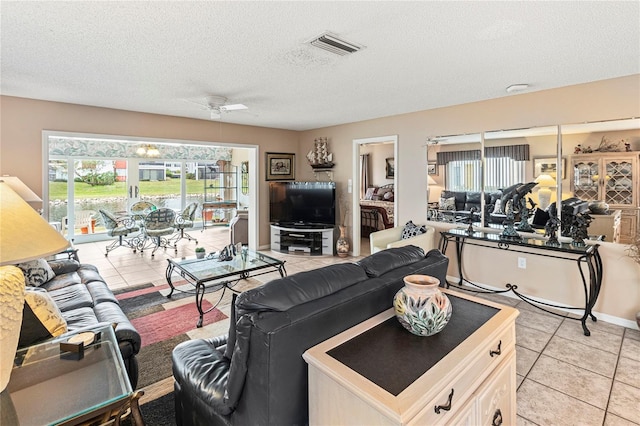 4714 Potomac Cir, Bradenton, FL 34210 - living area featuring light tile patterned floors, a ceiling fan, and a textured ceiling