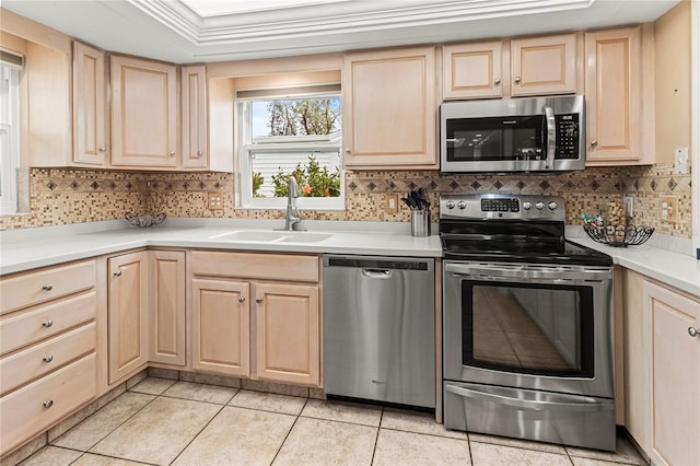 4714 Potomac Cir, Bradenton, FL 34210 - kitchen featuring appliances with stainless steel finishes, light brown cabinets, and tasteful backsplash