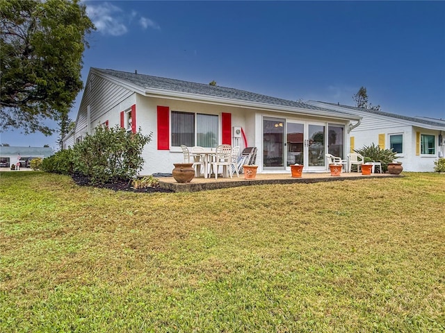 4714 Potomac Cir, Bradenton, FL 34210 - back of house with a yard, a patio area, and stucco siding