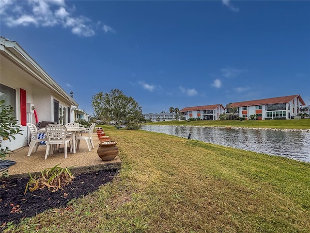 4714 Potomac Cir, Bradenton, FL 34210 - view of green lawn with a water view, a residential view, and a patio area