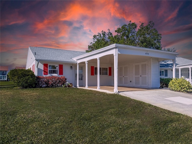 4714 Potomac Cir, Bradenton, FL 34210 - view of front facade with a carport, a lawn, and driveway