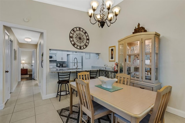 tiled dining room featuring a notable chandelier