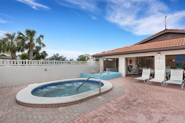 view of swimming pool featuring a hot tub and a patio