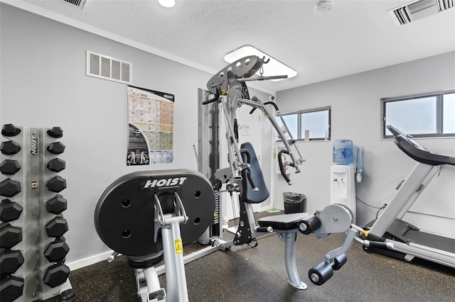 workout room featuring a textured ceiling