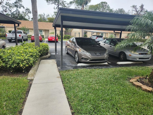 view of parking / parking lot featuring a yard and a carport