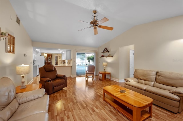 living room with ceiling fan, light hardwood / wood-style floors, and vaulted ceiling