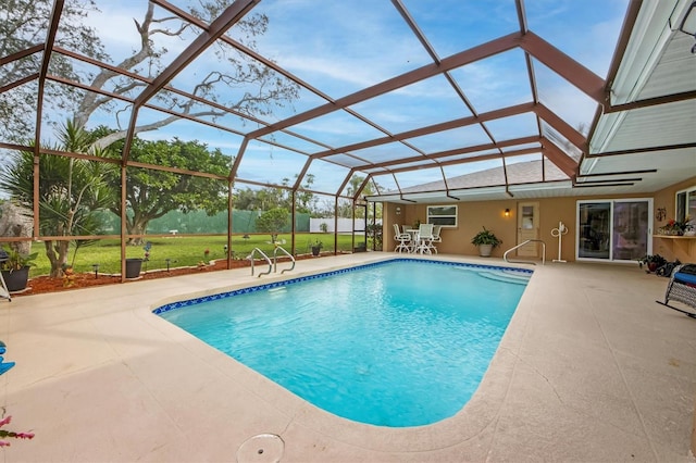 view of swimming pool with glass enclosure and a patio area