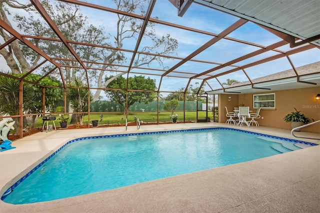 view of swimming pool with a lanai and a patio area