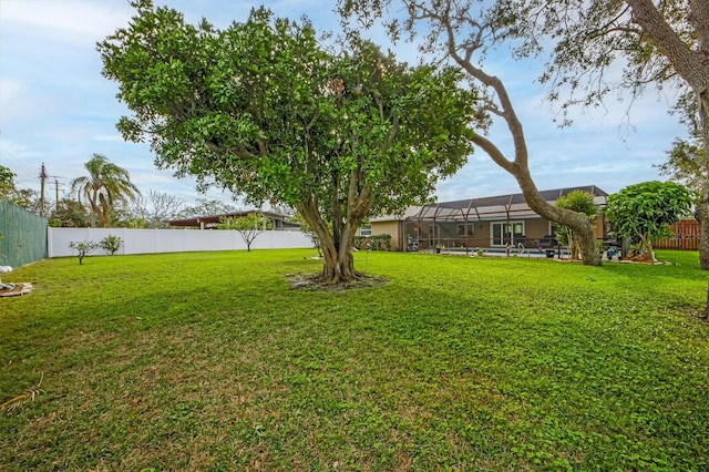 view of yard featuring glass enclosure