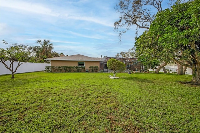 view of yard with glass enclosure