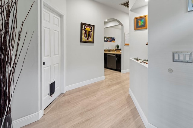 hall with sink and light wood-type flooring