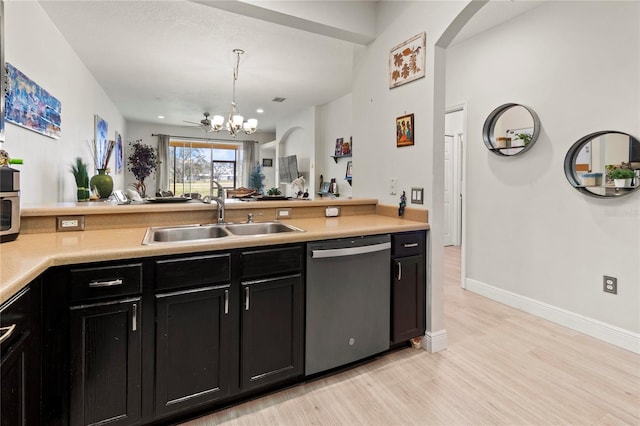 kitchen with sink, an inviting chandelier, hanging light fixtures, stainless steel dishwasher, and light wood-type flooring