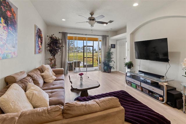 living room featuring ceiling fan and light hardwood / wood-style flooring