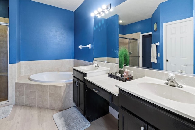 bathroom featuring vanity and separate shower and tub